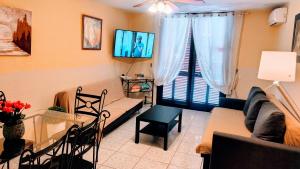 a living room with a couch and a table at Duplex Duo Parque Santiago 2 in Playa de las Americas