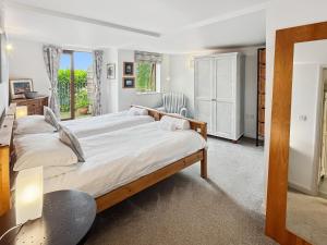 a bedroom with a large bed and a desk at St Anthony's Cottage in Porlock