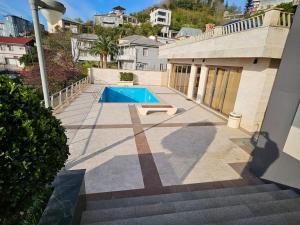 a swimming pool in the backyard of a house at Retro Villa in Batumi