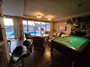 a living room with a pool table and a room with a pool table at Retro Villa in Batumi