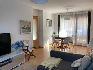 a living room with a couch and a table with chairs at AIzaetxea in Jaca