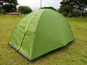 a green tent sitting on the grass in a field at Emplacement jardin pour tente Bayonne in Bayonne