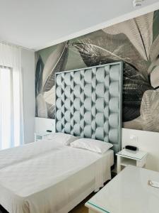 Postel nebo postele na pokoji v ubytování Hotel President