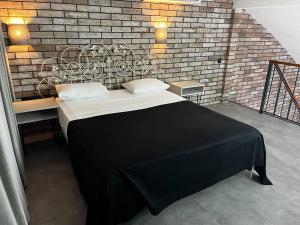 Voodi või voodid majutusasutuse Komilfo Hotel toas