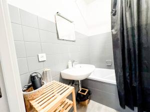 a white bathroom with a sink and a bath tub at Le Bali, studio évasion proche aéroport in Saint-Louis +9 photos