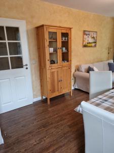 a living room with a couch and a cabinet at Ferienhof Bisdorf "Leuchtturm" in Bisdorf