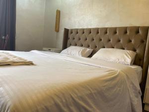 a bedroom with a large bed with a large white bedspread at زهرة المدائن in Jerash +12 photos