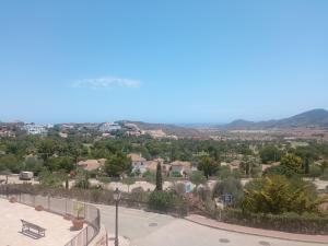a park with a bench and a view of a city at ELIO La Manga Club 5, golf & spa in La Manga del Mar Menor +45 photos