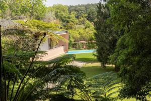 a view of a house with a swimming pool and trees at Casa da Ribeira in Colares