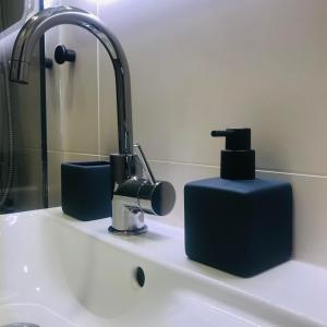 a sink with a faucet and a soap dispenser on it at La Galerie, Et Pop Et Chic ! in Poitiers