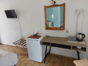 a bathroom with a sink and a mirror on the wall at Mirsini Rooms in Votsi +39 photos