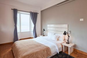 a bedroom with a large bed and a window at Ananya Apartments Phase 1 in Kathmandu