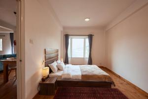 a bedroom with a large bed and a window at Ananya Apartments Phase 1 in Kathmandu