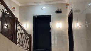 a hallway with a black door in a building at مسكن الفخامة in Taif +26 photos