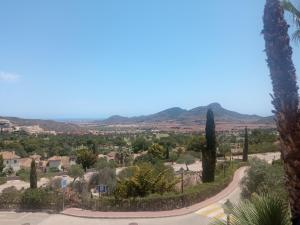 a view from the top of a hill with trees and a road at ELIO La Manga Club 5, golf & spa in La Manga del Mar Menor