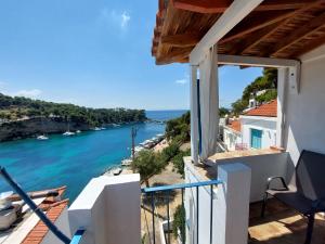 a view from the balcony of a house overlooking the water at Mirsini Rooms in Votsi