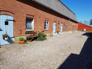 a brick building with a bunch of doors on it at Ferienhof Bisdorf "Bauernhaus" in Bisdorf