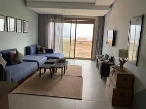 a living room with a blue couch and a table at Immi in Agadir