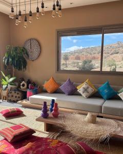 a living room with a couch with colorful pillows at Immi in Agadir
