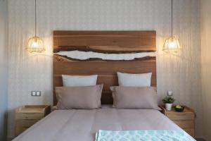 a bedroom with a large bed with two pillows at Immi in Agadir +10 photos