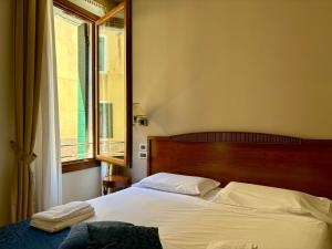 Postel nebo postele na pokoji v ubytování Locanda del Ghetto