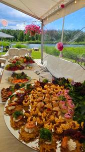 a group of plates of food on a table at Tūjas dīķi in Tūja