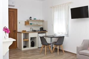 a small living room with a table and chairs at Skalopati Studios & Villa in Panormos Skopelos