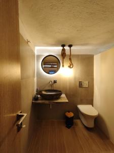 a bathroom with a sink and a toilet at Skopelos Mortero Cottage in Panormos Skopelos