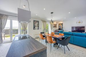 a living room with a dining table and a blue couch at Holiday House Rhapsody in Buzet