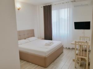 En eller flere senger på et rom på Hotel Restaurant Univers