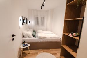 a small bedroom with a bed in a room at Atelier 51 - Free parking in Mostar