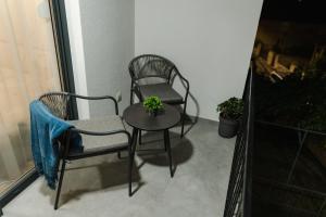 two chairs and a table on a balcony at Atelier 51 - Free parking in Mostar