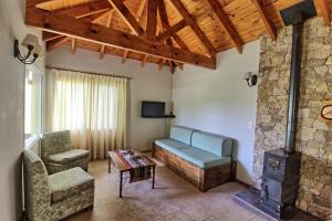 a living room with a couch and a fireplace at Casas de Campo Henin in Villa General Belgrano