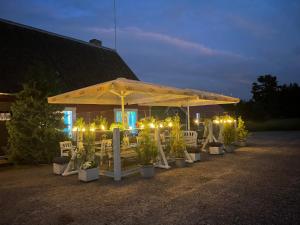 a group of tables and chairs under a tent with lights at Emmaste Teemaja in Emmaste