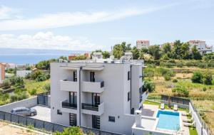 an aerial view of a white house with a swimming pool at Luxury Villa David 2 heated pool in Podstrana