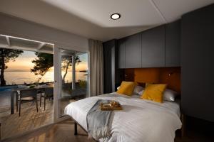 a bedroom with a bed and a view of the ocean at Terra Park Phalaris in Novalja