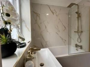 a bathroom with a sink and a shower at Glasgow Central Paradise - Spacious 3- Bed House in Glasgow