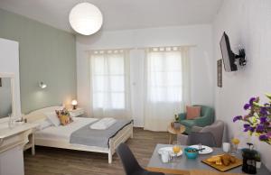 a bedroom with a bed and a living room at Skalopati Studios & Villa in Panormos Skopelos