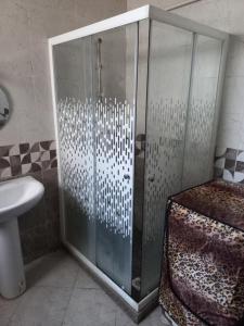 a shower with a glass door in a bathroom at Apartment in 6 October city in 6th Of October