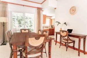 a dining room with a table and chairs at Secluded Garden Paradise Condo @Los Sueños in Herradura