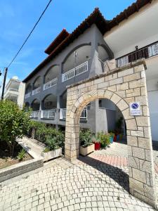 a building with an arch in front of it at ELPIDA View in Kallithea Halkidikis