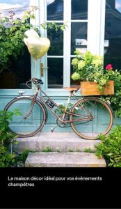 a bike parked in front of a house at Maison Sollier in Sainte-Croix
