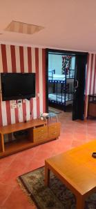 a living room with a flat screen tv on a wall at بورتو مارينا in El Alamein