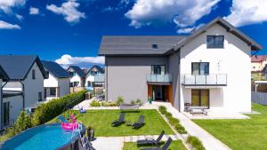 a house with a swimming pool and a backyard at Apartamenty Sea Colors - Basen i Sauna! Blisko Plaży - Bardzo Wysoki Standard in Jastrzębia Góra