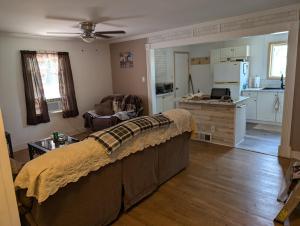 a living room with a couch and a kitchen at Landry's Laire in Crescent