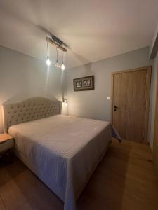 Ένα ή περισσότερα κρεβάτια σε δωμάτιο στο Elite Holiday Apartment