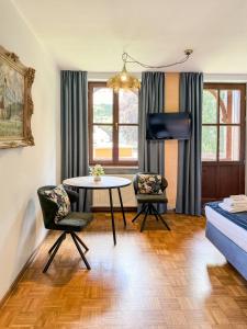 a living room with a table and two chairs at Villa Fantasia Budget Boutique Hotel in Füssen