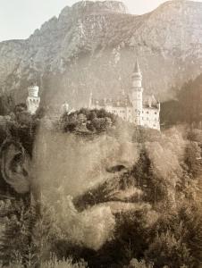 a black and white photo of a castle on a hill at Villa Fantasia Budget Boutique Hotel in Füssen