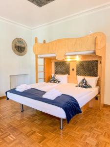a bedroom with a large bed with a wooden headboard at Villa Fantasia Budget Boutique Hotel in Füssen