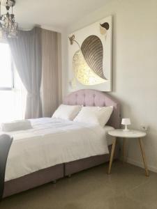 a bedroom with a large bed and a table at jomtien pattaya condo seaview room premium 33sqm in Jomtien Beach
